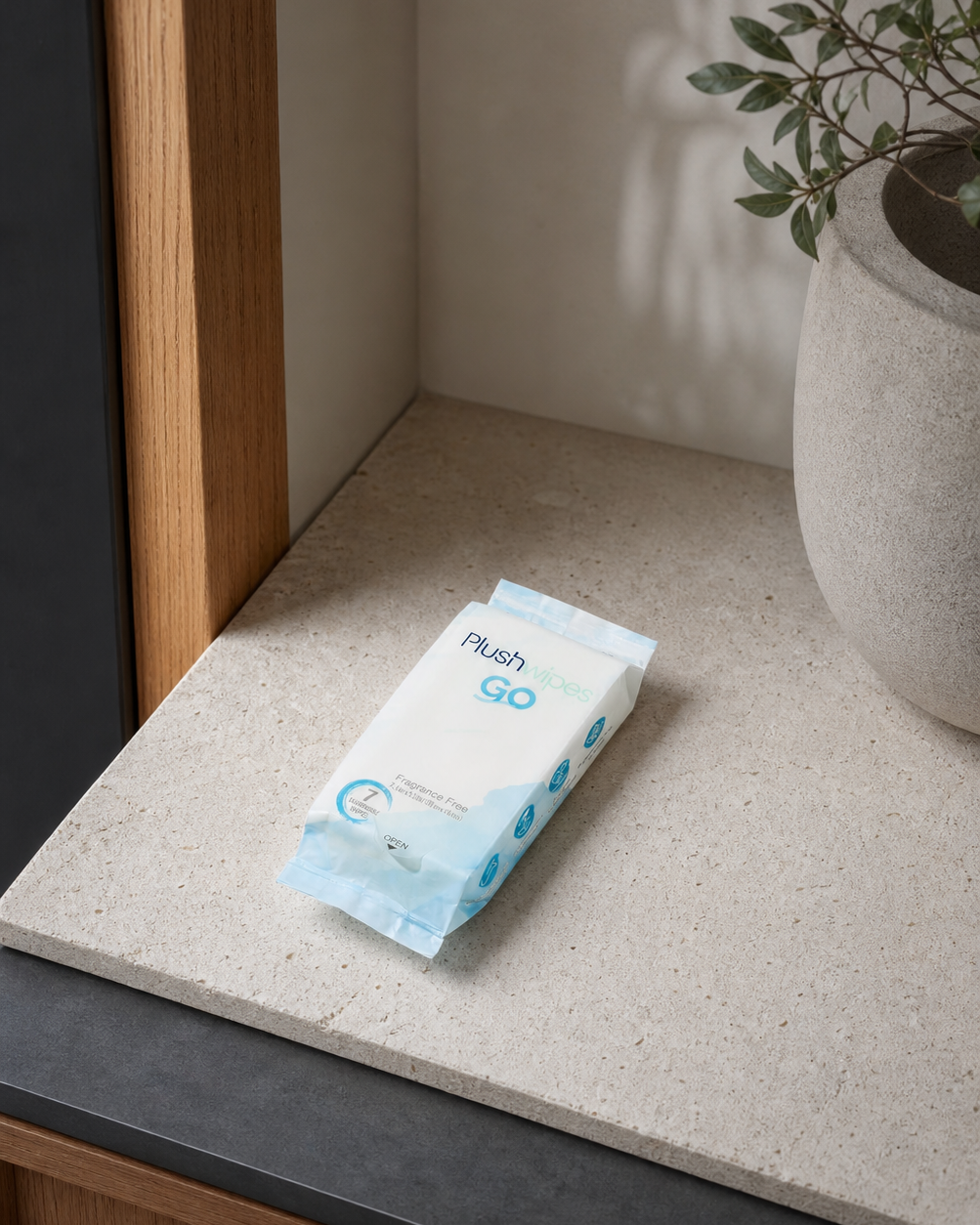 Plushwipes Go pocket pack naturally photographed on a limestone shelf