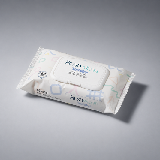 Plushwipes Toddler fragrance-free flushable wipes pouch on a soft gray background